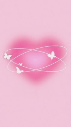 three white butterflies flying around a pink heart