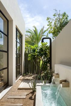 an outdoor hot tub in the middle of a patio with trees and plants around it