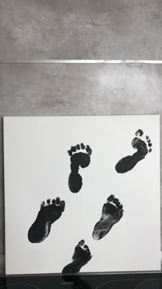 a black and white photo of footprints on a wall