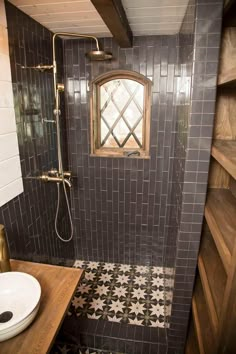 a bathroom with black and white tiles on the walls