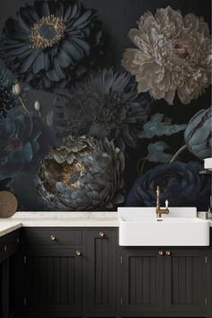 a black and white floral wallpaper in a bathroom with dark wood cabinets, a sink and faucet