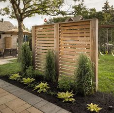 a wooden fence next to a lush green yard