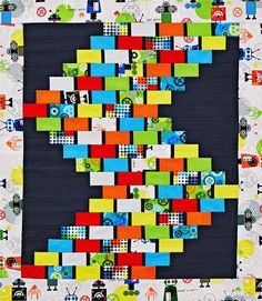 a quilted wall hanging with colorful blocks on it