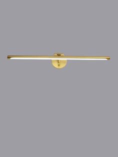 an image of a bathroom light fixture in gold tone with dim lighting on the side