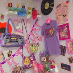 there are many items on the wall in this room, including t - shirts and toys