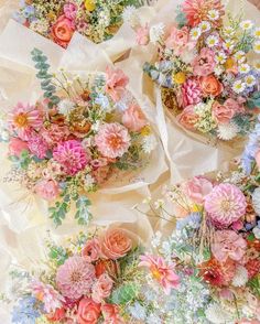 several bouquets of flowers are laid out on the table