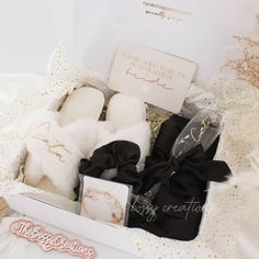 a white box with black and gold items in it