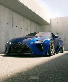 a blue sports car parked in front of a white building with concrete floors and walls