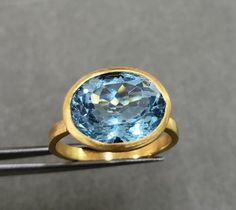 1. 18k Gold Sky Blue Topaz Ring 2. Made to Order 3. Gemstone - Blue Topaz 4. Jewelry Type - Gold Ring 5. Total weight - 4.280 Gram 6. Blue Topaz Weight - 6.55 Carats 7. Gold Weight - 2.970 Grams 8. Blue Topaz Size - 9 x 12 MM 9. Gold Purity - 18k 10. Band Size - 2.15 MM 11. Handmade Items 12. AAA Quality Ring 13. Stackable Ring 14. 1 Quantity Available 15. Ready to dispatch in 1 - 2 days. 16. Cut stone Pictures are taken under natural and day light. Topas Ring, Dainty Gold Ring, Sky Blue Topaz Ring, Gold Skies, Dainty Gold Rings, Jewelry Dainty, Stone Pictures, Etsy Gold Ring, 18k Gold Ring