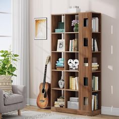 a living room with a guitar and bookshelf