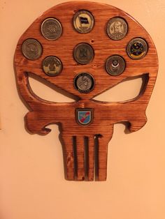 a wooden skull with lots of different coins on it's face is mounted to the wall