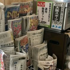 many newspapers are stacked on top of each other