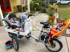 two young children sitting in their baby carriages