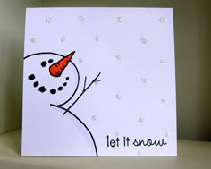 a card with a snowman holding a carrot on it's head and saying let it snow