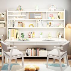 two white chairs sitting in front of a desk with bookshelves on top of it