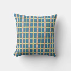 a blue and yellow plaid pillow sitting on top of a white wall