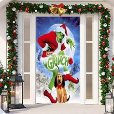 the grinch movie door cover is decorated with christmas wreaths and lights, while a dog sits in front of it