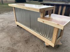 an outdoor bar made out of metal and wood