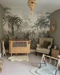 a baby's room with a crib, rocking chair and palm trees on the wall