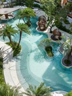 an outdoor swimming pool surrounded by palm trees