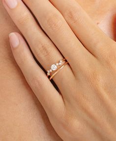 a woman's hand with a diamond ring on it