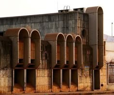 an old concrete building with arches and windows