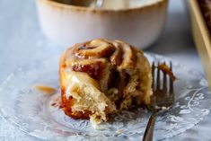 a piece of cinnamon roll on a plate with a fork