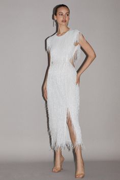 a woman in a white fringe dress