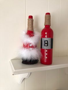 two bottles are sitting on a shelf next to each other, one is red and the other is white