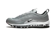 The Air Max 97 just looks right in the color silver. Whether it's the original "Silver Bullet" colorway or this Air Max 97 Premium "Reflect Silver" the metallic shade works well across the classic runner whose design was inspired by high speed trains in Japan. The Air Max 97 "Reflect Silver" has a mix of reflective silver and silver mesh paneling across the upper. A Swoosh by the midfoot and the tongue is done in black, while the heel tab has "Air Max" running down it in red. The sneaker has the Senior Clothes, Skater Shoes, Nike Silver, Glitter Sneakers, Silver Bullet, Stadium Goods, Loafer Sneakers, New Nike Air, Freshman Year