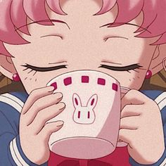 a girl drinking from a cup with her eyes closed and pink hair in front of her face