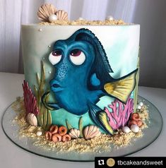 a cake decorated with an image of a blue fish and corals on the side