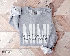 Elevate the joy of Mother's Day with our Personalized Mimi sweatshirt adorned with the sweet touch of grandkid names. This Mimi sweatshirt creates a heartfelt and stylish tribute to the cherished Mimi in your life. ✨Please check the SIZE CHART image on the listing, and choose your size accordingly before placing your order.  🚫We do not accept exchanges, returns, or cancellations, however, if there are any quality issues with the item please contact us right away. We'll be happy to make things r Nonna Gifts, Nana Sweatshirt, Mimi Gift, Mama Sweater, Custom Sweaters, Nana Gifts, Mama Sweatshirt, Kid Names, The Sweet