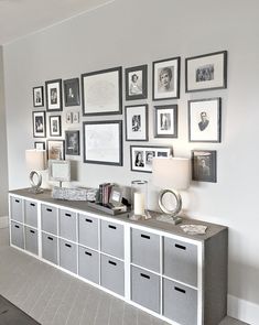 a room with many pictures on the wall and some drawers in front of each other