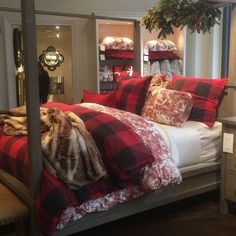 a bed room with a neatly made bed and lots of pillows on top of it