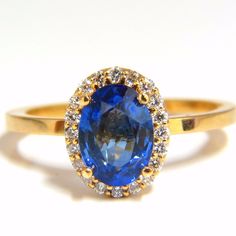 Blue Sapphire & Halo Deco 1.88ct. Natural Blue Sapphire Ring. Vivid Blue Color Clean Clarity. Oval Full Cut 8.1 X 6mm Transparent, Vibrant Blue Color .31ct. Side Natural Round Diamonds: G-Color, Vs-2 Clarity. 18kt. Yellow Gold 3 Grams. Deck Of Ring: 10.6 X 8.2mm Current Ring Size: 6 May Be Resized. $4,500 Appraisal Certificate To Accompany Pink Moissanite Engagement Ring, Sapphire Anniversary Ring, Moissanite Engagement Ring White Gold, Jewelry Sapphire, Blue Sapphire Diamond Ring, Gold Leaf Rings, Pear Shaped Engagement Rings, Fancy Yellow Diamond, Ruby Diamond Rings