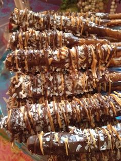 chocolate covered pretzels are arranged on a glass platter