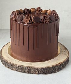 a chocolate cake sitting on top of a wooden slice