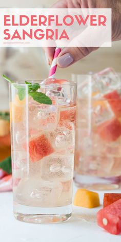 someone holding a straw in a glass filled with watermelon and lemonade sangria