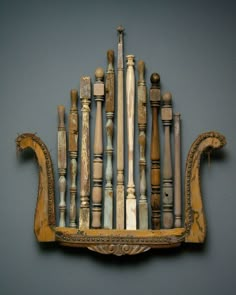 an old wooden shelf with many different types of wood decorations on the top and bottom