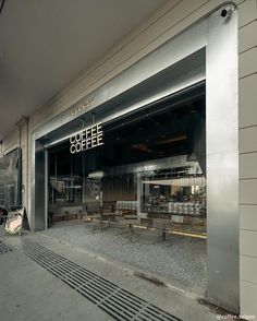 the outside of a coffee shop with tables and chairs