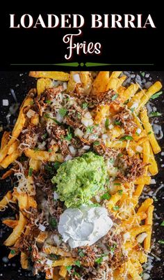 loaded burrito fries with guacamole and sour cream on top, topped with shredded parmesan cheese