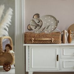 there is a basket on top of the table with lights in it and a teddy bear