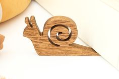 a wooden toy snail sitting on top of a table