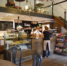 two women working behind the counter in a bakery