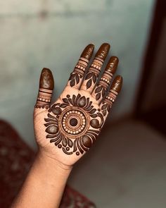 a woman's hand with henna on it