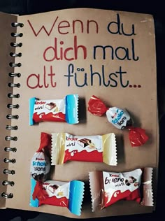 an open notebook with candy bars on it and the words wern du dich malt fuhlst