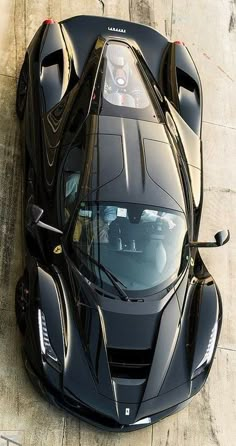 a black sports car is parked on the street