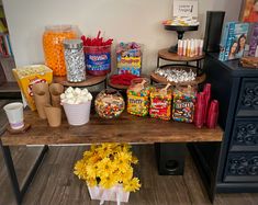 a table with candy, candies, and other items on it in front of a dresser