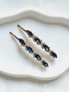 Add a touch of elegance to your hairdo with these stunning dark blue rhinestone and gold diamante bobby pins. The perfect hair accessories for any occasion, especially weddings.  Made from high quality metal and features a sparkling gold finish, making them a great addition to any bridal or bridesmaid outfit.  Can be worn at proms, party and other formal occasions. You will receive 1 pair of hair clip for the price. Measurements: length 9cm, width 1 cm Ship with Royal Mail. Express delivery avai Diamante Hair, Hair Pins Wedding, Dark Blue Hair, Wedding Barrettes, Women Hair Accessories, Bridesmaid Outfit, Blue Rhinestones, Bride Hairstyles, Wedding Hair Accessories